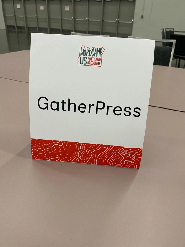 GatherPress signage at the WCUS Contributor Day table